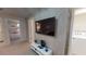 Upstairs bonus room with a TV, neutral carpet and decor plus laundry room access at 1569 Carey Palm Cir, Kissimmee, FL 34747