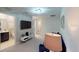 Upstairs bonus room with a TV, neutral carpet and decor plus a full bathroom access at 1569 Carey Palm Cir, Kissimmee, FL 34747