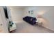 Bright upstairs bonus room with a comfortable blue sofa and modern decor at 1569 Carey Palm Cir, Kissimmee, FL 34747