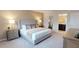 The bedroom has a king bed with plush bedding and neutral colors, creating a serene and inviting atmosphere at 1569 Carey Palm Cir, Kissimmee, FL 34747