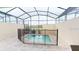 Swimming pool surrounded by a screened enclosure and a safety fence at 1569 Carey Palm Cir, Kissimmee, FL 34747