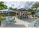 Poolside bar with seating and shaded umbrellas for relaxing with friends and Gathering at 1569 Carey Palm Cir, Kissimmee, FL 34747