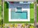 Backyard aerial view featuring a swimming pool, hot tub, putting green, patio, and manicured lawn at 15727 Vetta Dr, Montverde, FL 34756