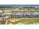 Aerial view showcasing a residential community next to a golf course at 15727 Vetta Dr, Montverde, FL 34756
