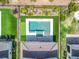 Aerial view of a backyard with a swimming pool, spa, putting green, patio, and well-manicured lawn at 15727 Vetta Dr, Montverde, FL 34756