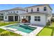 Spacious backyard features a pool, spa, covered patio, putting green, and lush landscaping at 15727 Vetta Dr, Montverde, FL 34756