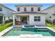 A spacious backyard features a pool, spa, covered patio, and lush landscaping, perfect for outdoor living at 15727 Vetta Dr, Montverde, FL 34756