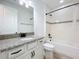 Well-lit bathroom with granite countertops, white subway tile, and modern fixtures at 15727 Vetta Dr, Montverde, FL 34756