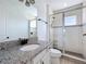 Bright bathroom features a granite countertop vanity and glass-enclosed shower with white subway tile surround at 15727 Vetta Dr, Montverde, FL 34756