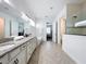 Serene bathroom with a dual sink vanity, standalone tub, and a walk-in shower with glass enclosure at 15727 Vetta Dr, Montverde, FL 34756