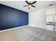 Bedroom featuring dark accent wall, neutral carpet, and bright natural light at 15727 Vetta Dr, Montverde, FL 34756