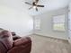Spacious room with neutral carpet, a ceiling fan, and views from the windows at 15727 Vetta Dr, Montverde, FL 34756