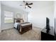 Bedroom with comfortable bed, natural light, and a modern dresser at 15727 Vetta Dr, Montverde, FL 34756