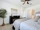 Cozy bedroom showcasing a dark wood dresser, decorative artwork, and soft neutral tones at 15727 Vetta Dr, Montverde, FL 34756