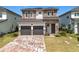 Beautiful two-story home featuring stone accents, a two-car garage, and a meticulously maintained front lawn at 15727 Vetta Dr, Montverde, FL 34756