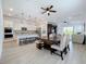 Open-concept kitchen with white cabinetry, a large center island, and a dining area perfect for gatherings at 15727 Vetta Dr, Montverde, FL 34756