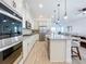 Bright, open kitchen with stainless steel appliances, granite countertops, and a central island with bar seating at 15727 Vetta Dr, Montverde, FL 34756
