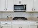 Kitchen featuring stainless steel appliances, granite countertops, and white cabinets with modern hardware at 15727 Vetta Dr, Montverde, FL 34756