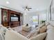 Cozy living room with a large sectional couch, entertainment center, and sliding doors to the outdoor space at 15727 Vetta Dr, Montverde, FL 34756
