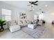 Open living room with ample seating, stylish decor, and seamless flow to the kitchen and dining area at 15727 Vetta Dr, Montverde, FL 34756