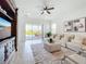 Inviting living room features a large sectional sofa, decorative rug, and sliding glass doors to the patio at 15727 Vetta Dr, Montverde, FL 34756