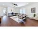 Bright living room featuring modern decor, wood floors, and comfortable seating at 15727 Vetta Dr, Montverde, FL 34756