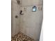 Contemporary shower with stylish mosaic tile flooring, clean white walls, and sleek fixtures at 2075 Huntsman Ridge Rd, Clermont, FL 34715