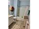 Well-lit bathroom featuring a tub/shower combination, vanity, and rustic wood accents at 2075 Huntsman Ridge Rd, Clermont, FL 34715