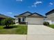 Inviting single-Gathering home with a spacious two-car garage and pristine lawn in a friendly neighborhood at 2075 Huntsman Ridge Rd, Clermont, FL 34715