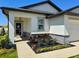 Inviting front entrance with colorful landscaping and a cozy, covered porch at 2075 Huntsman Ridge Rd, Clermont, FL 34715