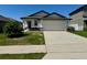 Charming single-story home with a well-manicured lawn and two-car garage at 2075 Huntsman Ridge Rd, Clermont, FL 34715