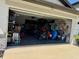 Spacious garage filled with storage and recreational items, offering ample space and functionality at 2075 Huntsman Ridge Rd, Clermont, FL 34715