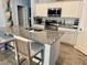 Gourmet kitchen featuring granite countertops, stainless steel appliances, and stylish barstool seating at 2075 Huntsman Ridge Rd, Clermont, FL 34715