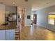 Open-concept living area with wood-look flooring that connects a stylish kitchen with stainless appliances at 2075 Huntsman Ridge Rd, Clermont, FL 34715