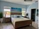 Serene main bedroom with an abundance of natural light, modern furnishings, and an attached ensuite bathroom at 2075 Huntsman Ridge Rd, Clermont, FL 34715