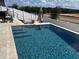 Modern pool with lounge seating and stone surround at 2075 Huntsman Ridge Rd, Clermont, FL 34715
