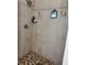 Modern shower with mosaic tile floor and sleek fixtures, providing a luxurious feel at 2075 Huntsman Ridge Rd, Clermont, FL 34715