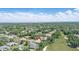 Scenic aerial view of the property highlighting its golf course location, landscaping and lake view at 216 Hammock Oak Cir, Debary, FL 32713