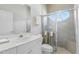 Bathroom showcasing a glass door shower with an oval window and a bright vanity area at 216 Hammock Oak Cir, Debary, FL 32713