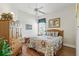 Cozy bedroom with floral bedding, hardwood floors, a large window, and ample storage at 216 Hammock Oak Cir, Debary, FL 32713