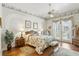 Inviting bedroom with floral wallpaper, hardwood floors, and access to an outdoor patio at 216 Hammock Oak Cir, Debary, FL 32713