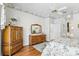 Bedroom featuring floral wallpaper, hardwood floors, and a spacious dresser at 216 Hammock Oak Cir, Debary, FL 32713