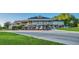 Exterior shot of the clubhouse with golf carts lined up in front at 216 Hammock Oak Cir, Debary, FL 32713