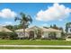 Charming single-story home with lush landscaping, palm trees, and a tile roof at 216 Hammock Oak Cir, Debary, FL 32713
