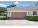 A two car garage with a tile roof and manicured landscaping at 216 Hammock Oak Cir, Debary, FL 32713