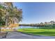 Picturesque view of the golf course and lake featuring a fountain at 216 Hammock Oak Cir, Debary, FL 32713