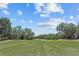 Expansive view of the golf course, with bright green grass under a sunny sky at 216 Hammock Oak Cir, Debary, FL 32713