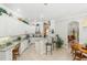 Well-lit kitchen with white cabinetry, a breakfast bar, and an adjacent casual dining area at 216 Hammock Oak Cir, Debary, FL 32713