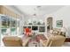 The living room offers a fireplace, large windows overlooking the pool and stylish decor at 216 Hammock Oak Cir, Debary, FL 32713