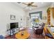 Well-lit living room featuring a ceiling fan, desk area, and French doors leading to the outdoors at 216 Hammock Oak Cir, Debary, FL 32713